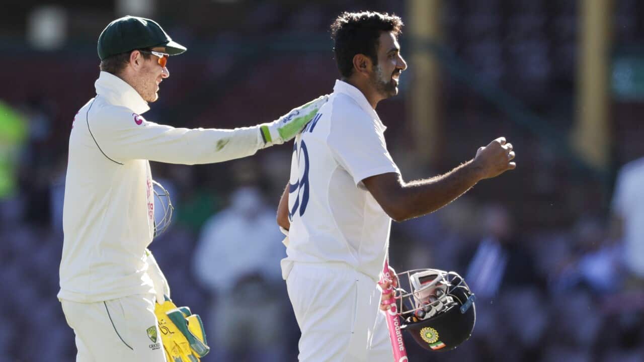 Australian captain Tim Paine, left, congratulates not out batsman India's Ravichandran Ashwin following play on the final day of the third cricket test.