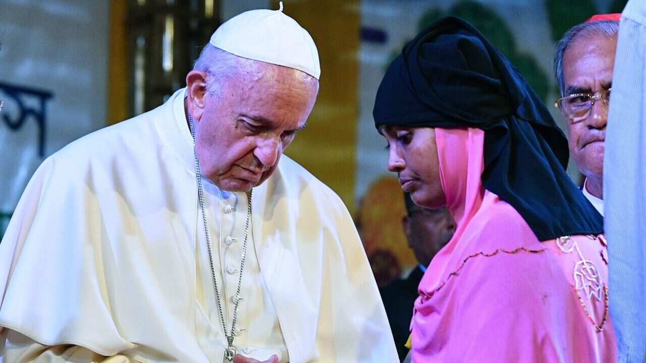 Pope Francis meets with a Rohingya refugee at the archbishop's residence in Dhaka.