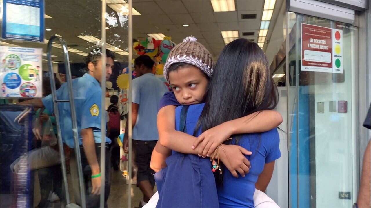 Maria is carried into hospital by her mother, Yoli.