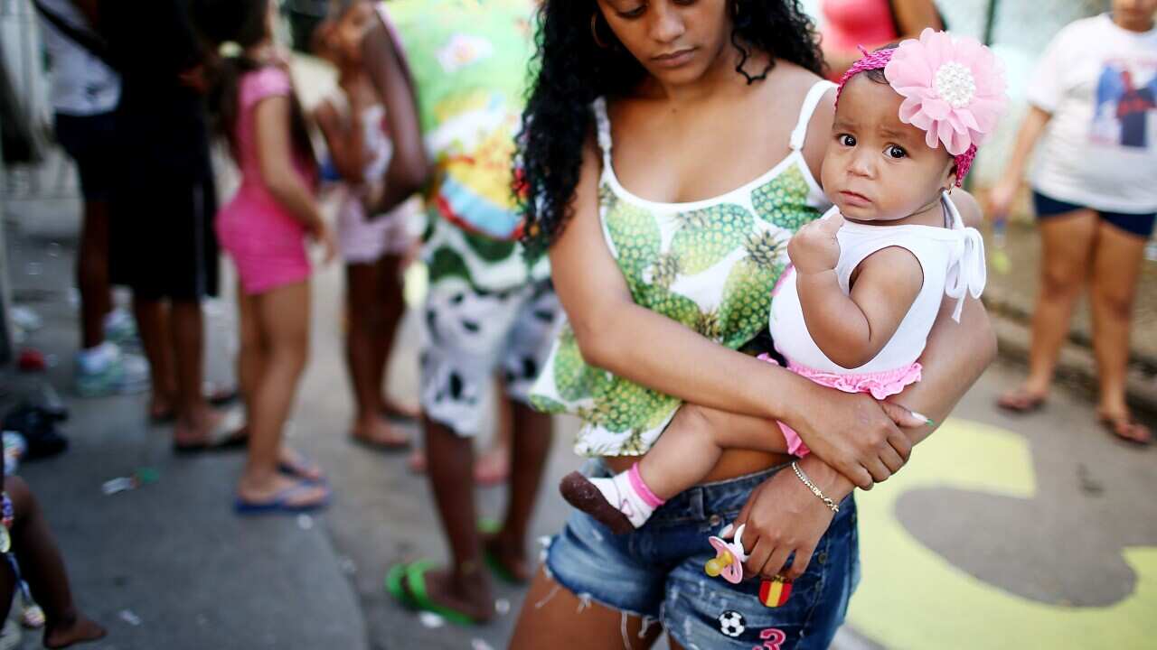 Woman holding child in Brazil.