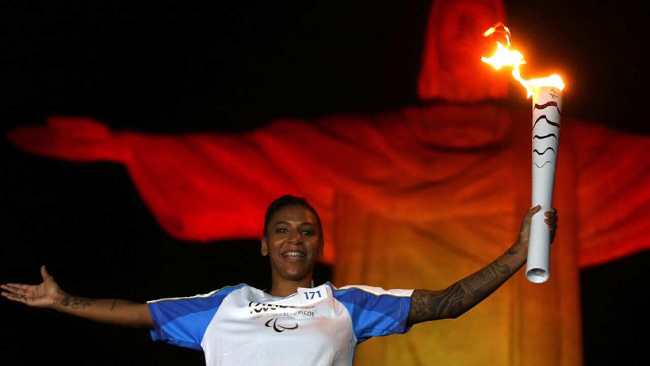 Olympic gold medalist Rafaela Silva holds the Paralympic Torch