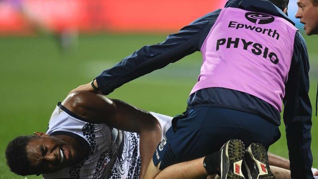 Esava Ratugolea of the Cats lays on the field injured.