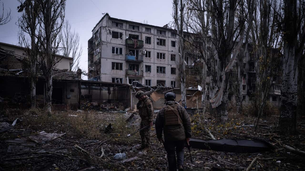 Ukrainian servicemen checking the area next to destroyed buildings in the frontline town of Kostyantynivka