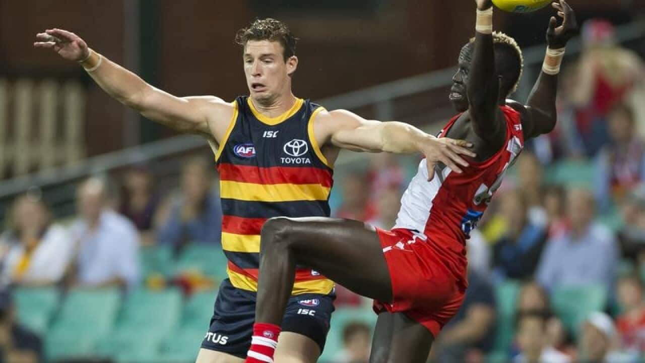 Josh Jenkins (left) and Aliir Aliir (right) contest a mark.