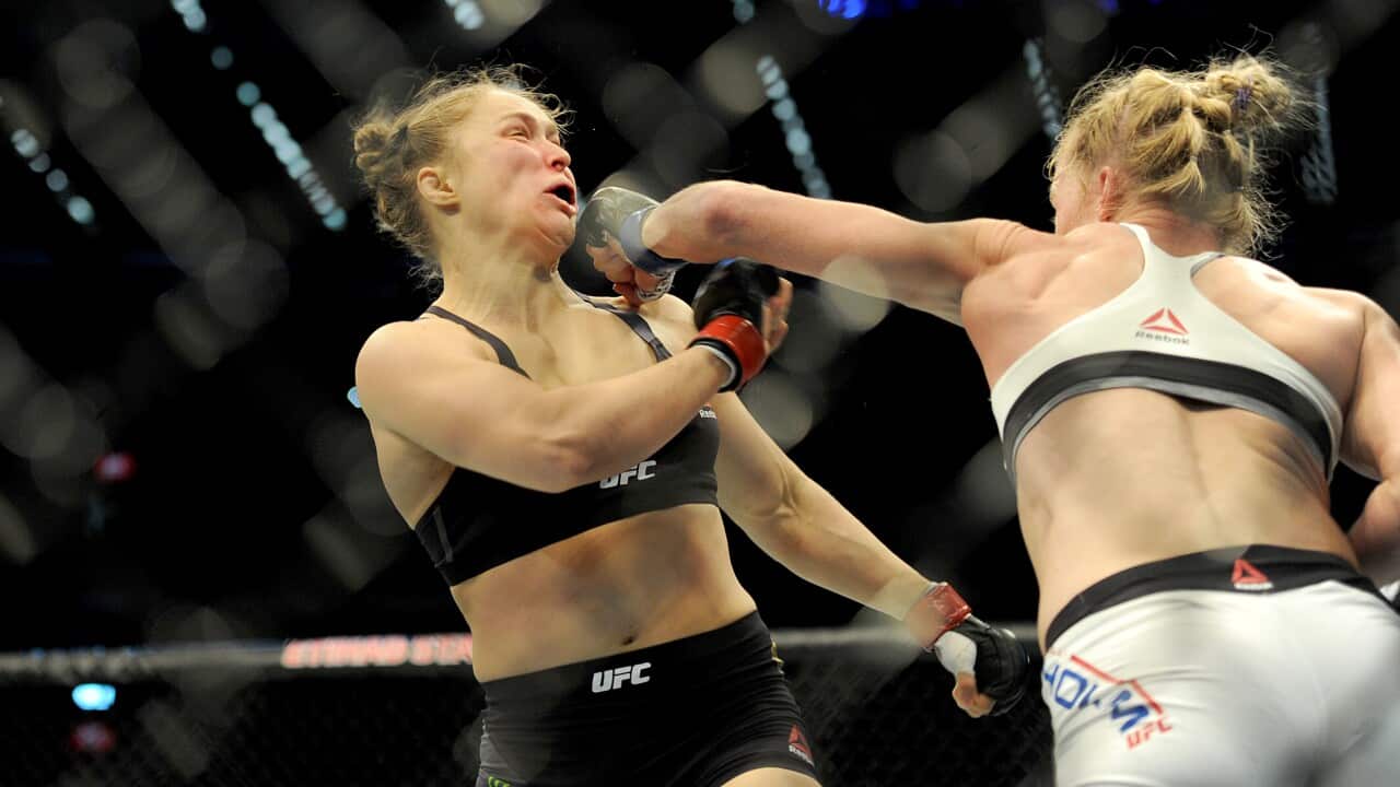 Holly Holm strikes defending champion Ronda Rousey in the Women's Bantamweight Bout during the UFC 193 Australia event at Etihad stadium in Melbourne 
