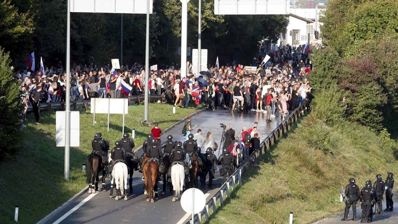 Riot police block a protest against vaccination measures in Ljubljana, Slovenia
