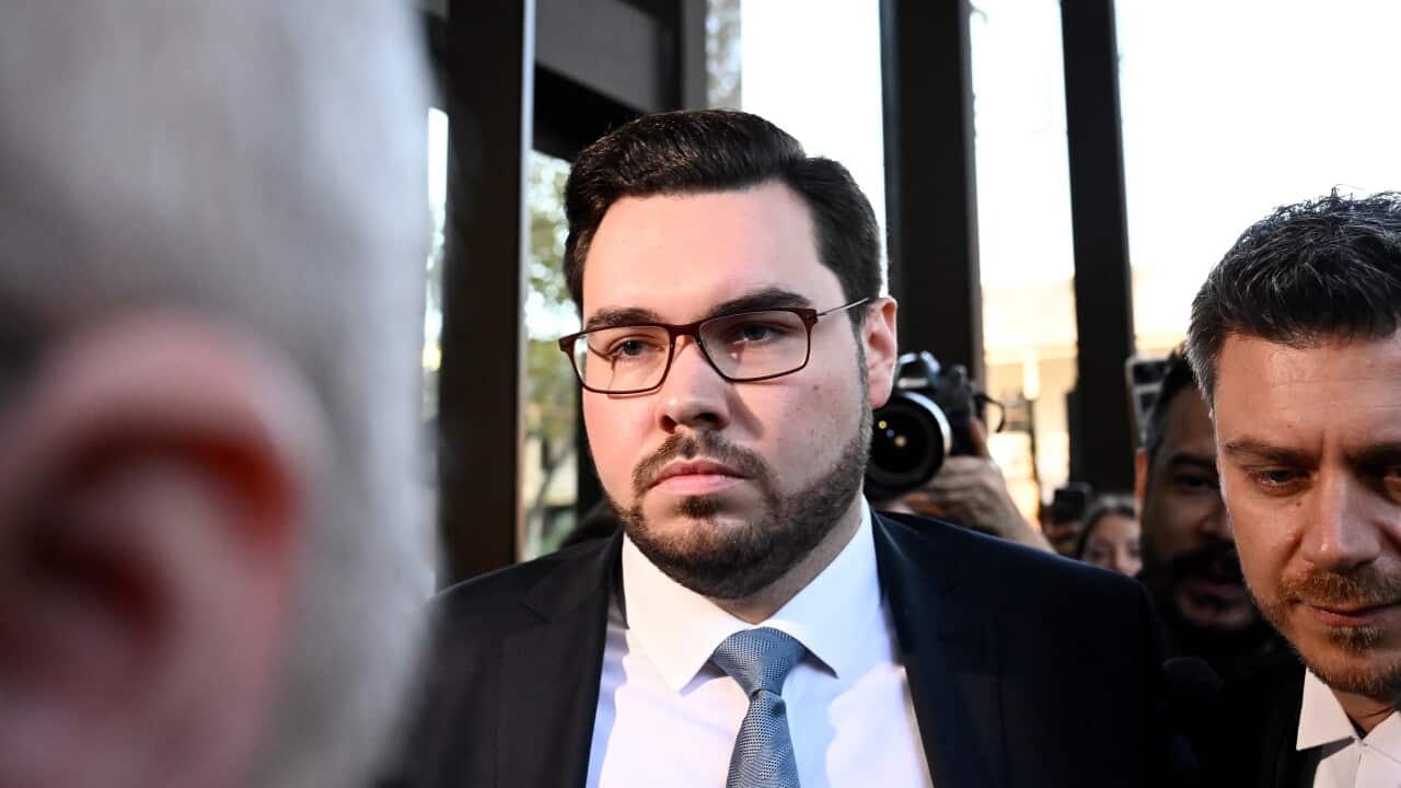 Bruce Lehrmann wearing a suit and tie outside court