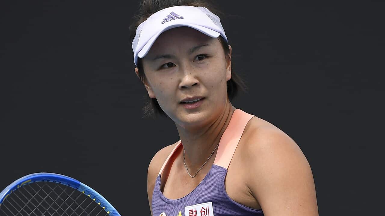 Peng Shuai holds a tennis racquet.