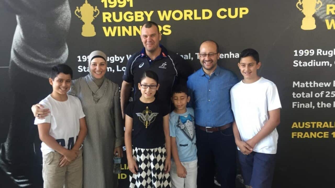 Raja Yassine with her family and Wallabies coach Michael Cheika at the launch of Rugby Australia's new campaign