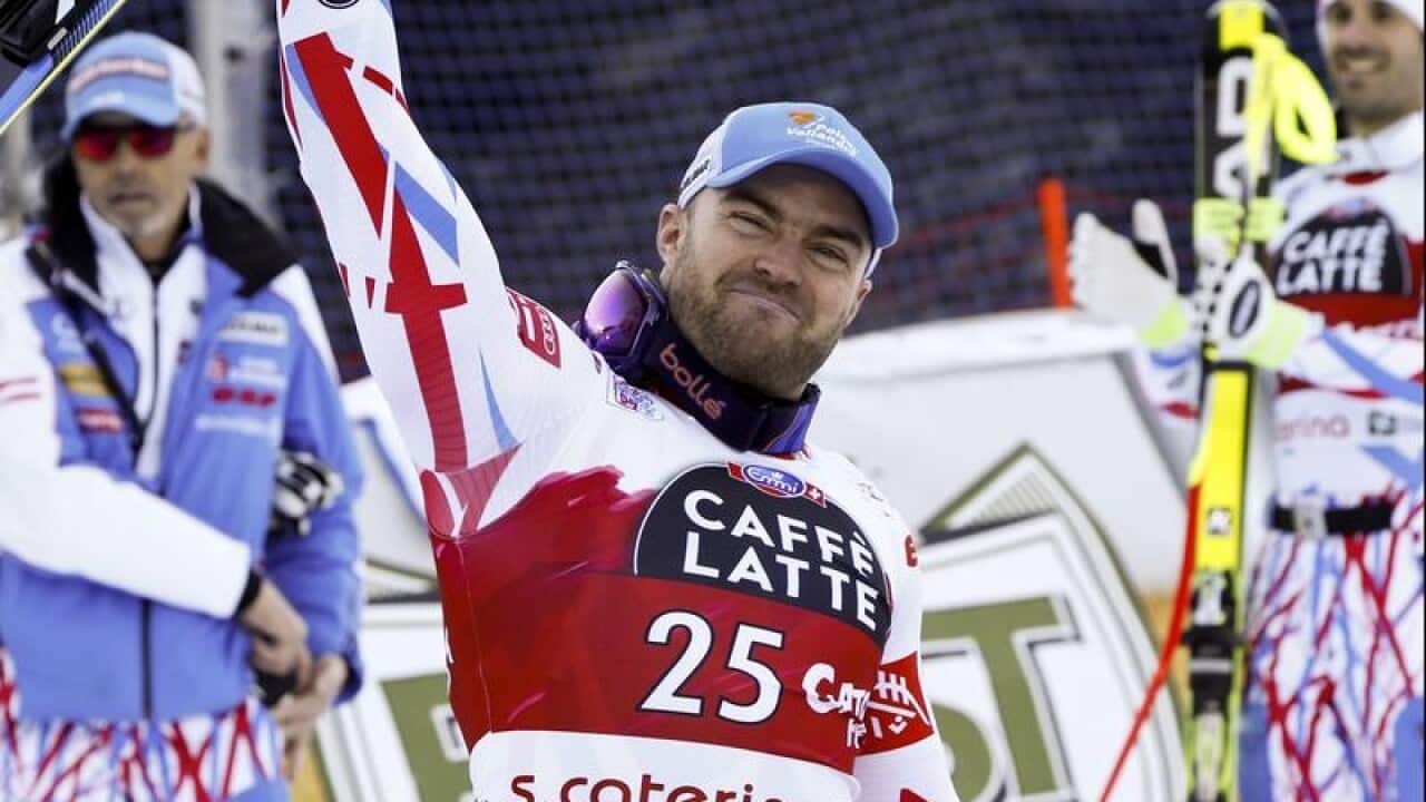 France's David Poisson celebrates after completing men's WC downhill.