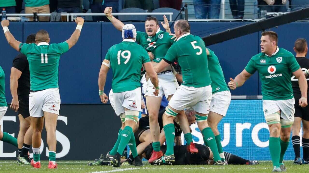 Ireland's Robbie Henshaw, center, celebrates with teammates after scoring against New Zealand during the second half of a rugby match Saturday, Nov. 5, 2016