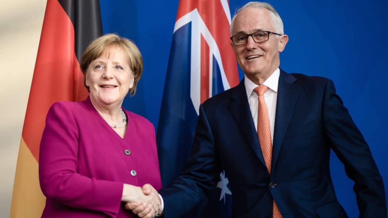 German Chancellor Angela Merkel (L) shakes hands with Australian Prime Minister Malcolm Turnbull (L) during a press statement at the Chancellery in Berlin