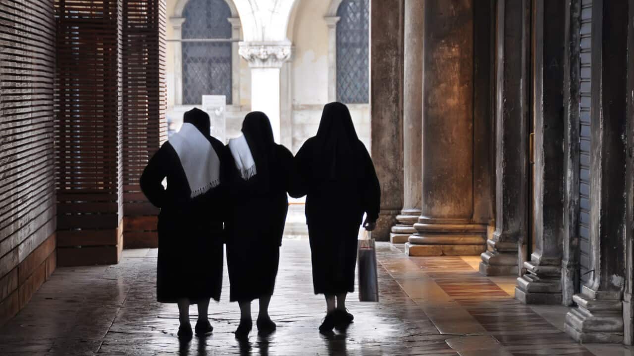 Three religious sisters walking in Venice