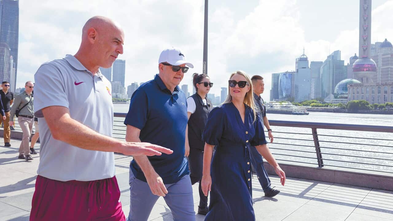Prime Minister Anthony Albanese and his fiancŽ Jodie Haydon walk along the Bund with former Socceroo and Shanghai Port F