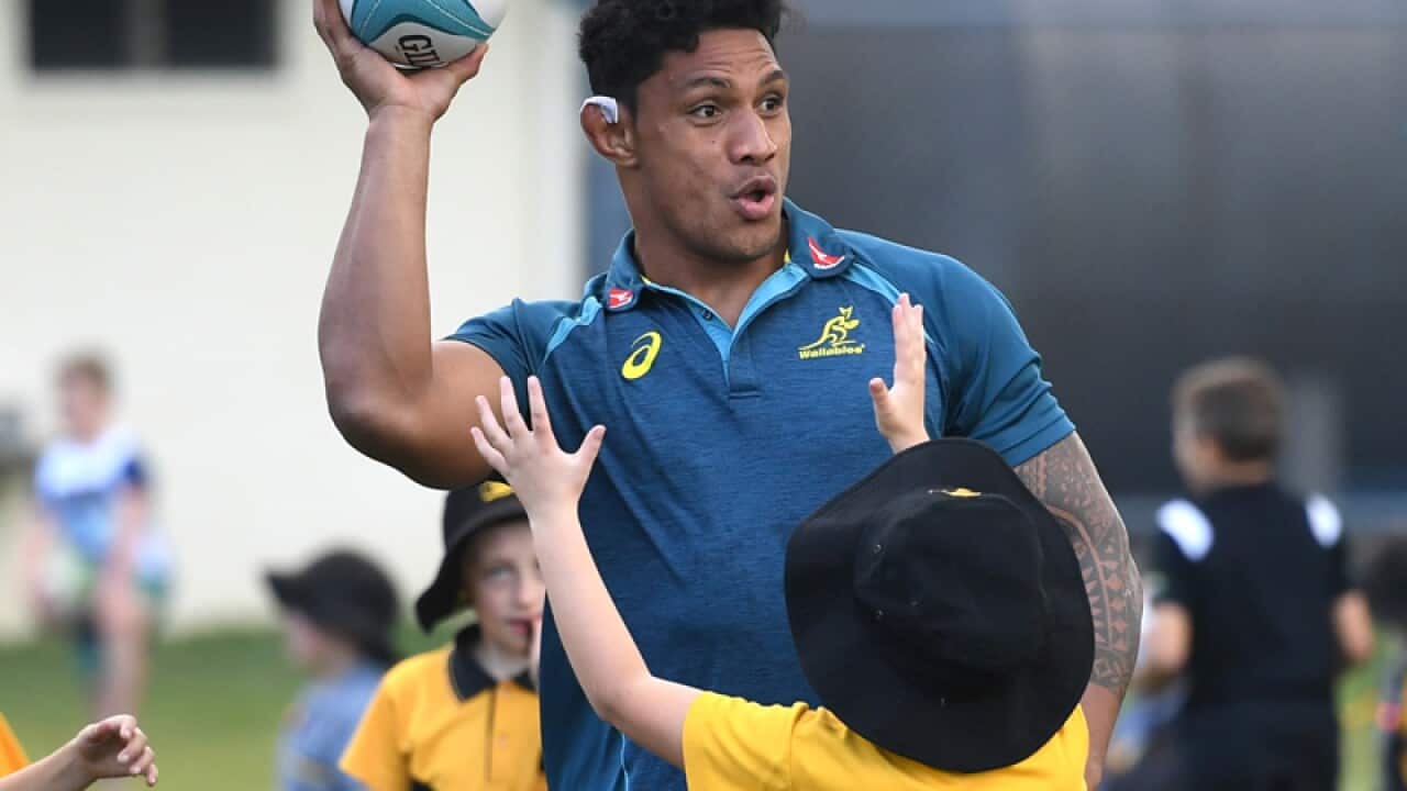 Wallabies player Lopeti Timani plays with children