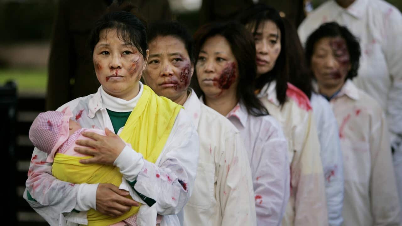 A file photo of protesters opposed to the Chinese authorities acting out alleged atrocities against Falun Gong members in Sydney, September, 2007. 