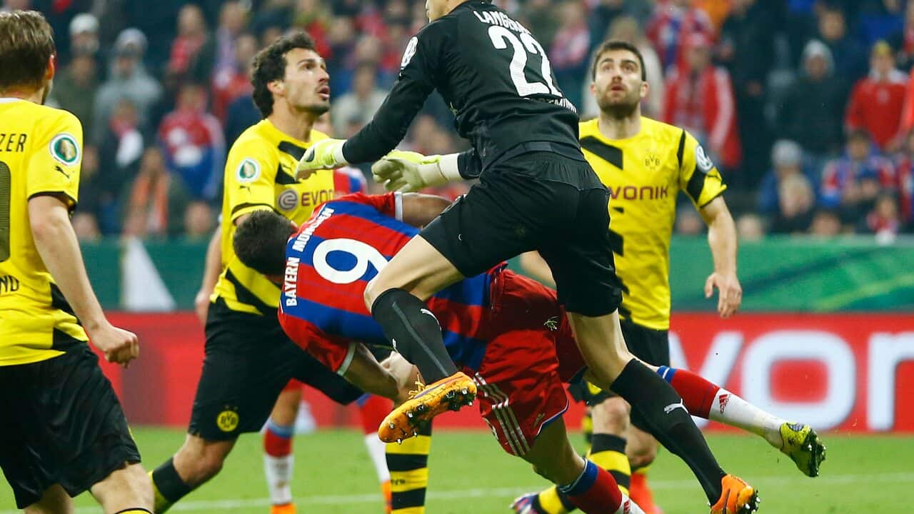 Bayern Munich's Robert Lewandowski goes down after colliding with Burussia Dortmund's Australian goalkeeper Mitchell Langerak (AP)
