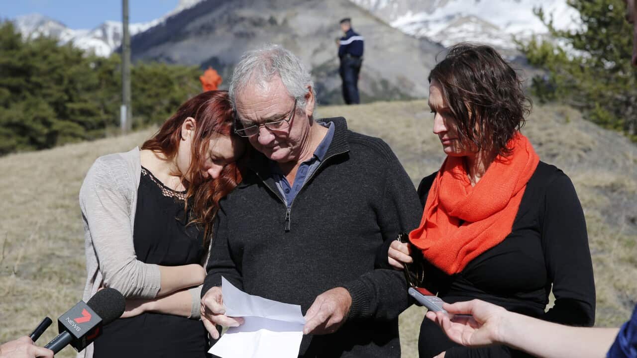 The brother of Carol Friday and uncle of Greig Friday, Malcolm Coram (centre), and his two daughters Philippa (left) and Georgina (right), make a statement at the memorial in Le Vernet, France, March 30, 2015.  (AAP Image/EPA, Yolan Valat)