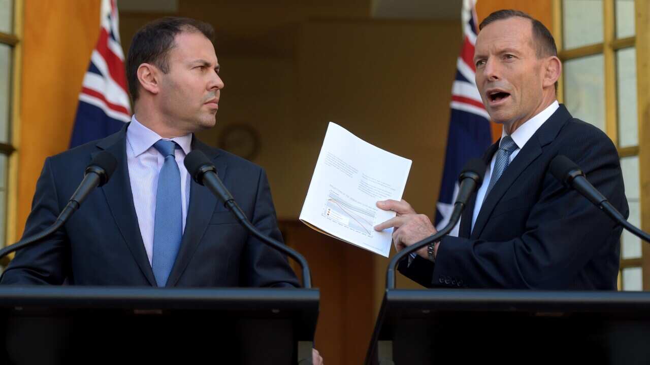 Australian Prime Minister Tony Abbott (right) and Assistant Treasurer Josh Frydenberg speak during a joint press conference at Parliament House in Canberra, Wednesday, March 18, 2015. (AAP Image/Lukas Coch) NO ARCHIVING