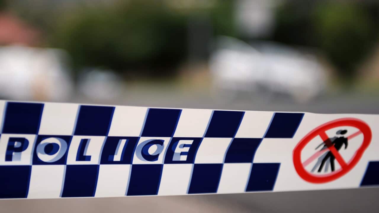Police tape restricts access to a street