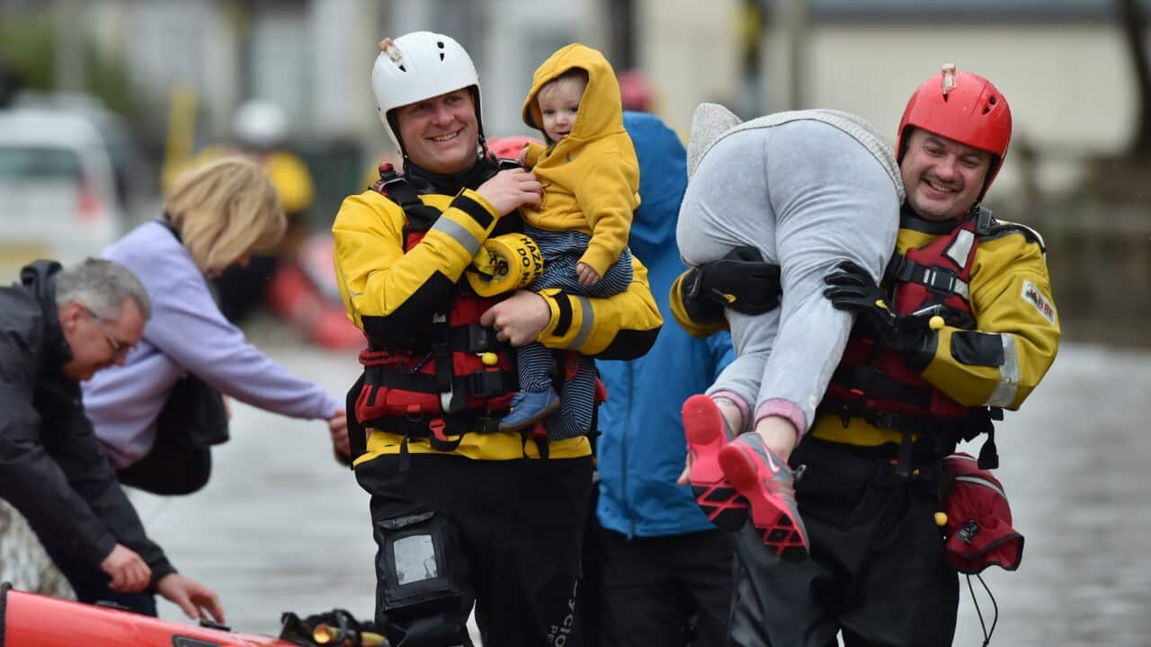 Emergency service personnel rescuing people caught in flooding in Nantgarw, near Cardiff in South Wales