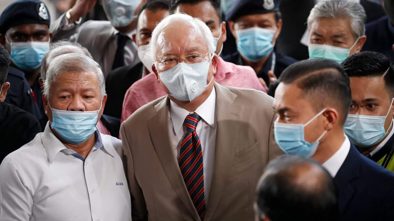 Former Malaysian Prime Minister Najib Razak, center, upon arrival at the court house in Kuala Lumpur, Malaysia, Tuesday, July 28, 2020.