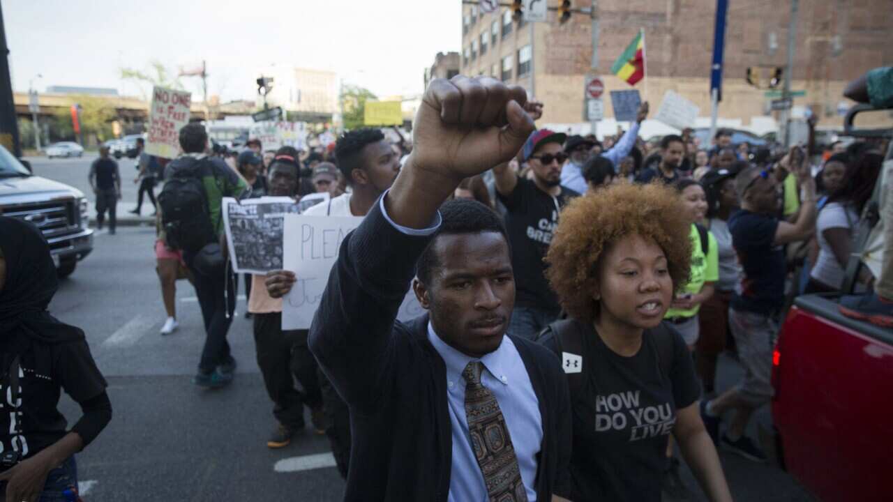Protesters march near City Hall in Baltimore, Maryland, USA, 29 April 2015, against the death in police custody of Freddie Gray. (EPA/JOHN TAGGART)