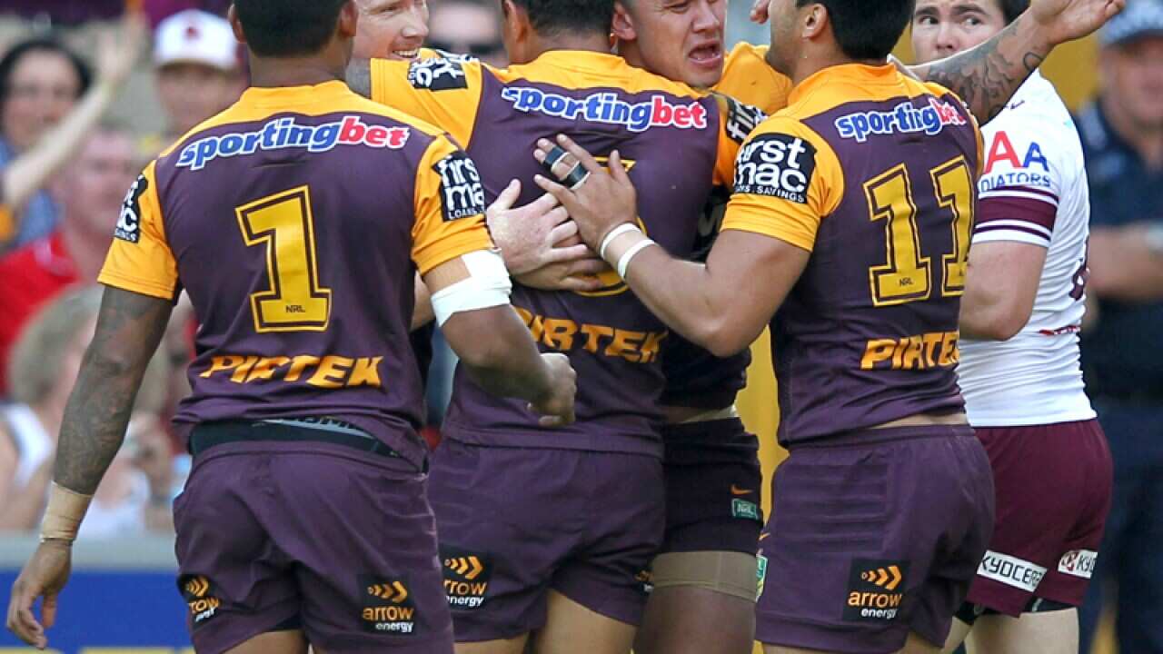 Broncos players celebrate a try