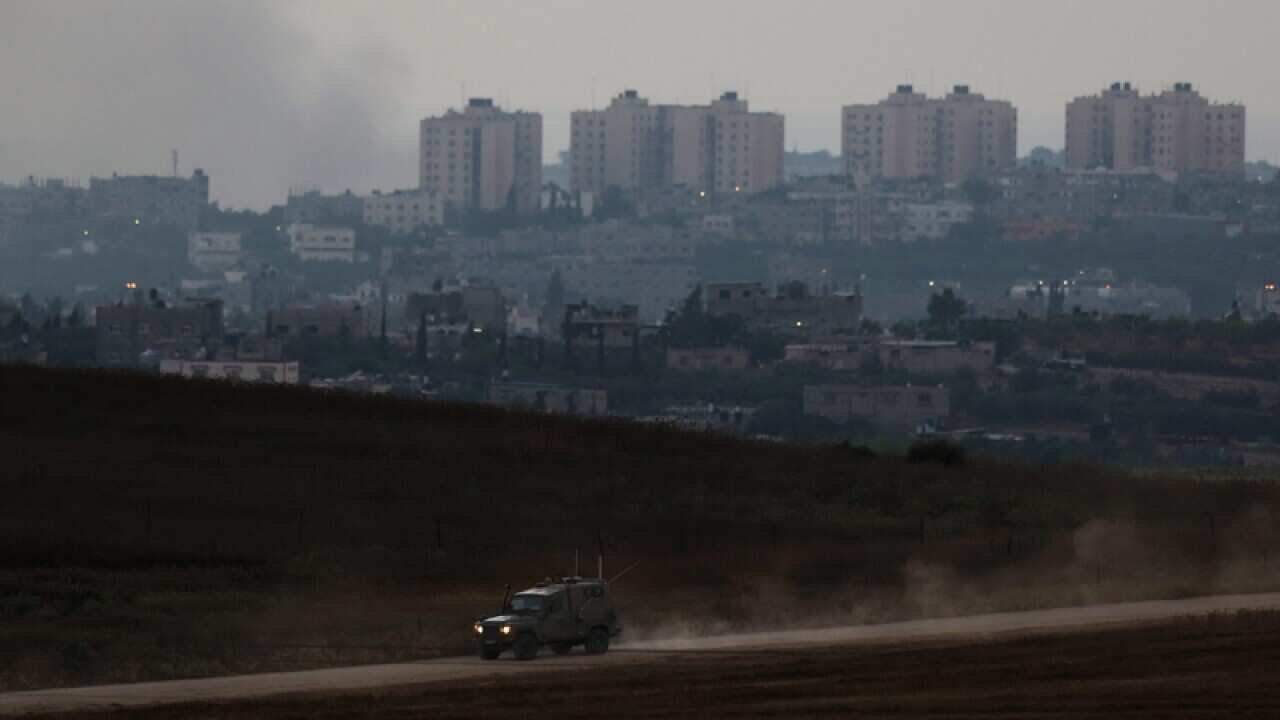 Israeli military cars patrol near the Israeli border with Gaza Strip.