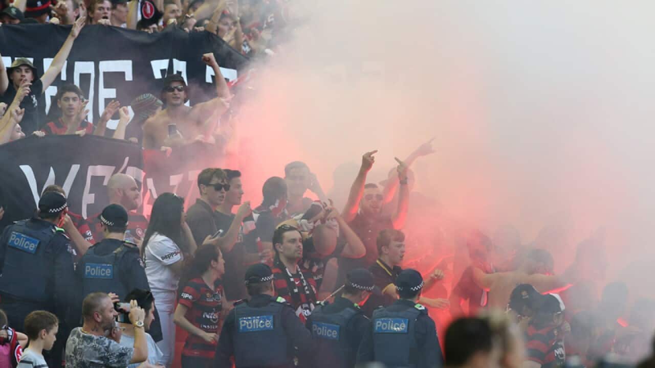 Fans let off flares during the round 18 A-League match