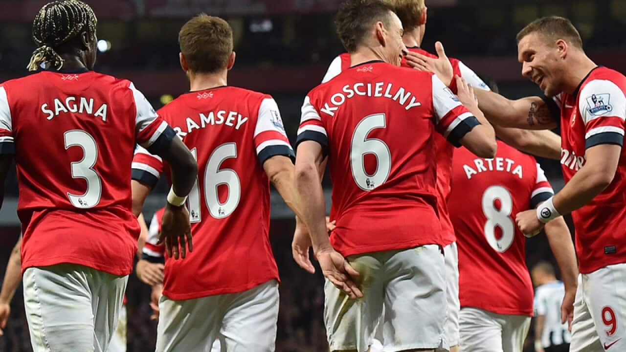Arsenal players celebrate after scoring a goal