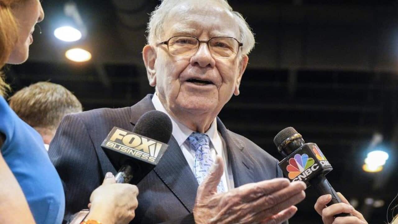 Berkshire Hathaway CEO Warren Buffett talks to the press