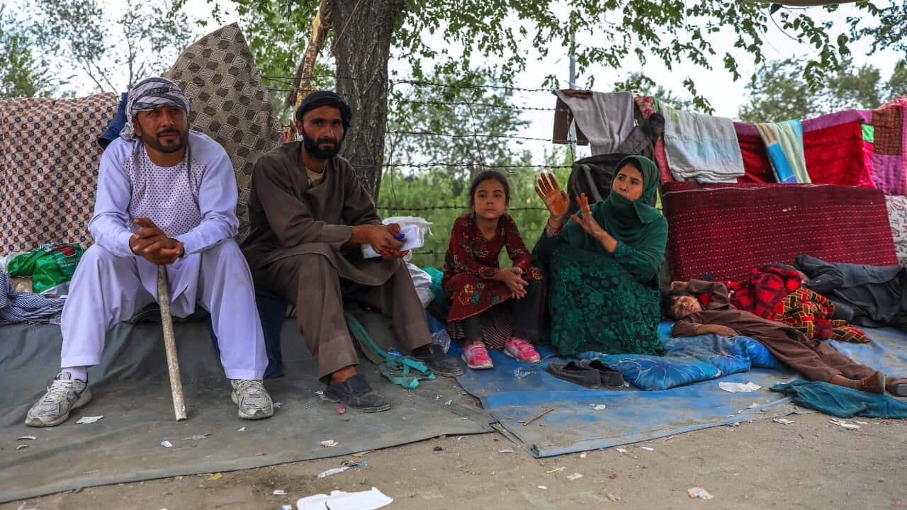 Families who fled fighting in Afghanistan's northern provinces shelter in a public park in Kabul, Afghanistan on 14 August 2021.