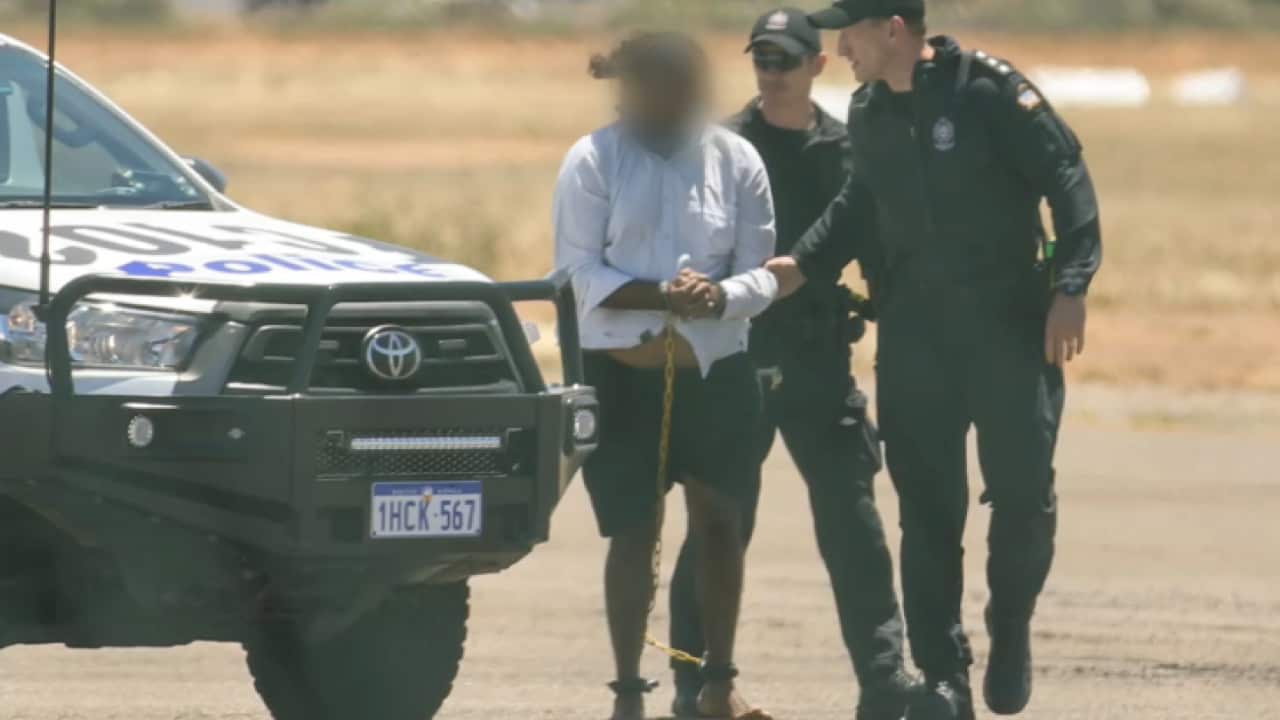 WA Police escort Cleo Smith's alleged abductor in handcuffs.