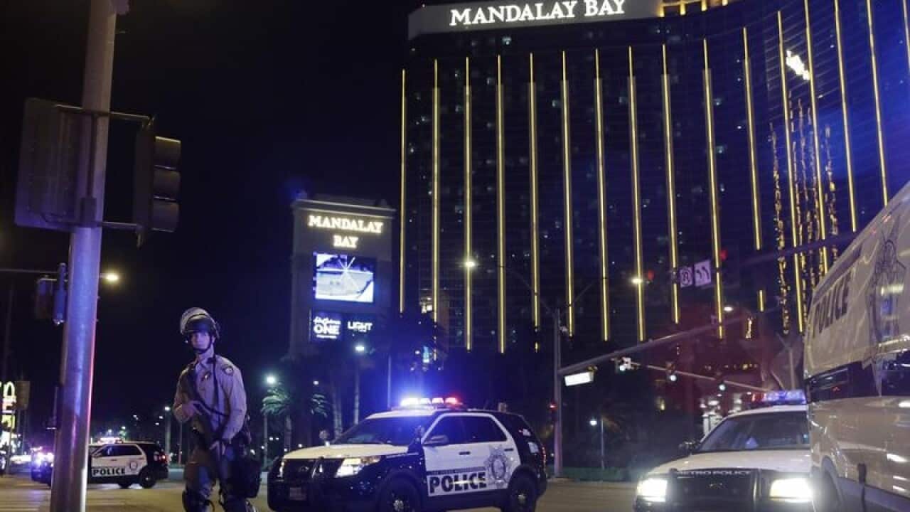 Police officers stand on the Las Vegas Strip following the shooting.