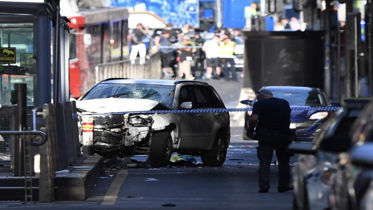 A damaged vehicle is seen at the scene of an incident