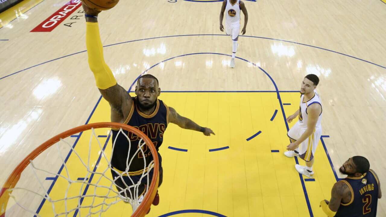 Cleveland Cavaliers forward LeBron James (L)