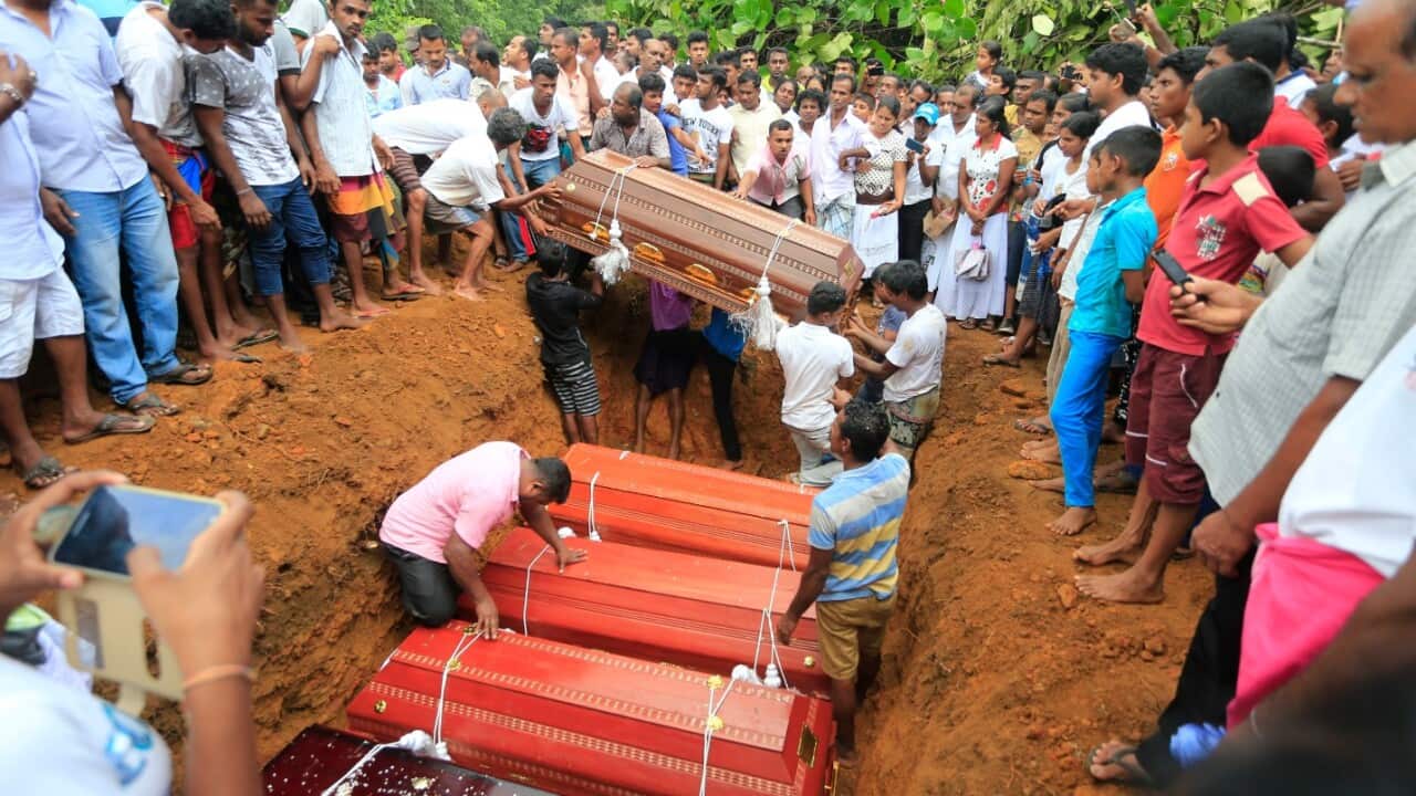 Sri Lankan villagers prepare to bury victims of a landslide at a cemetery in Bellana village, in Kalutara district in, Sri Lanka, Saturday, May 27, 2017.