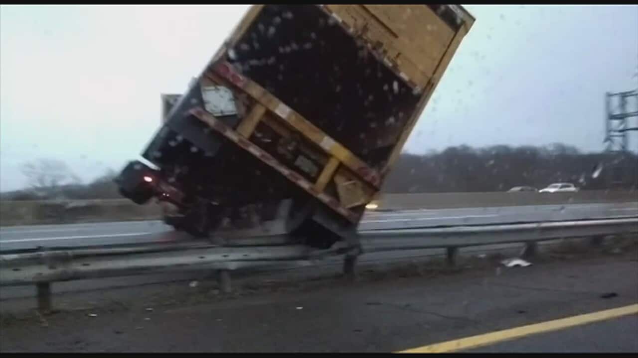 A driver in the US has filmed a large semi-trailer careening off the road on an icy highway in New Jersey.