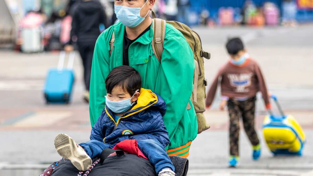 People at Guangzhou main railway station wearing protective masks.