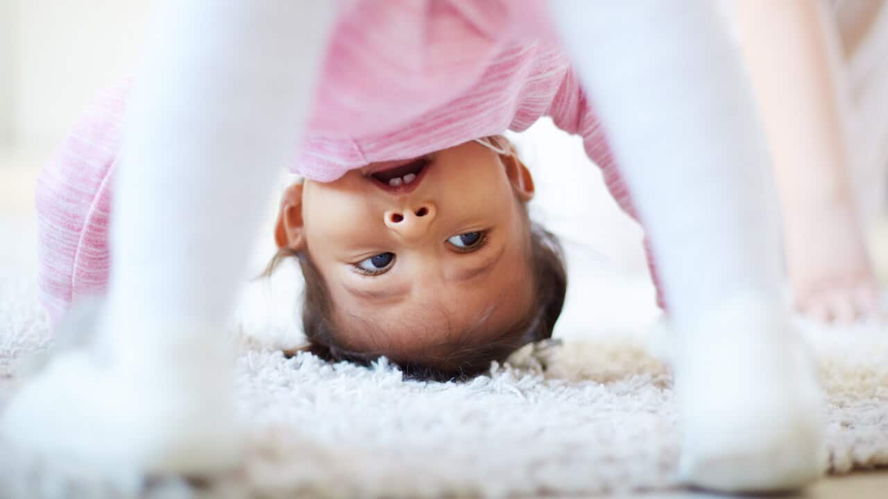 Active little girl somersaulting