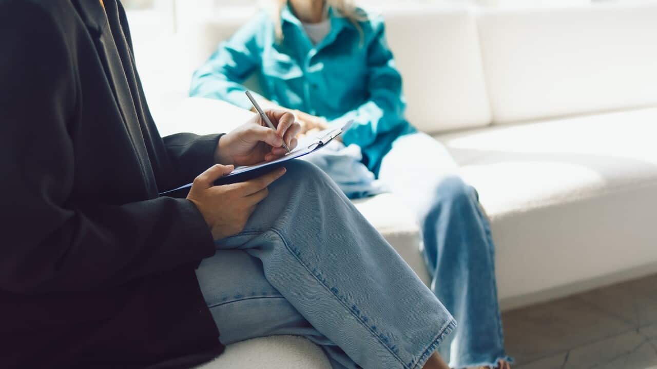 Two women sitting in armchairs and talking. Female coach, psychotherapist, psychologist, advisor and patient, client, psychotherapy, job interview