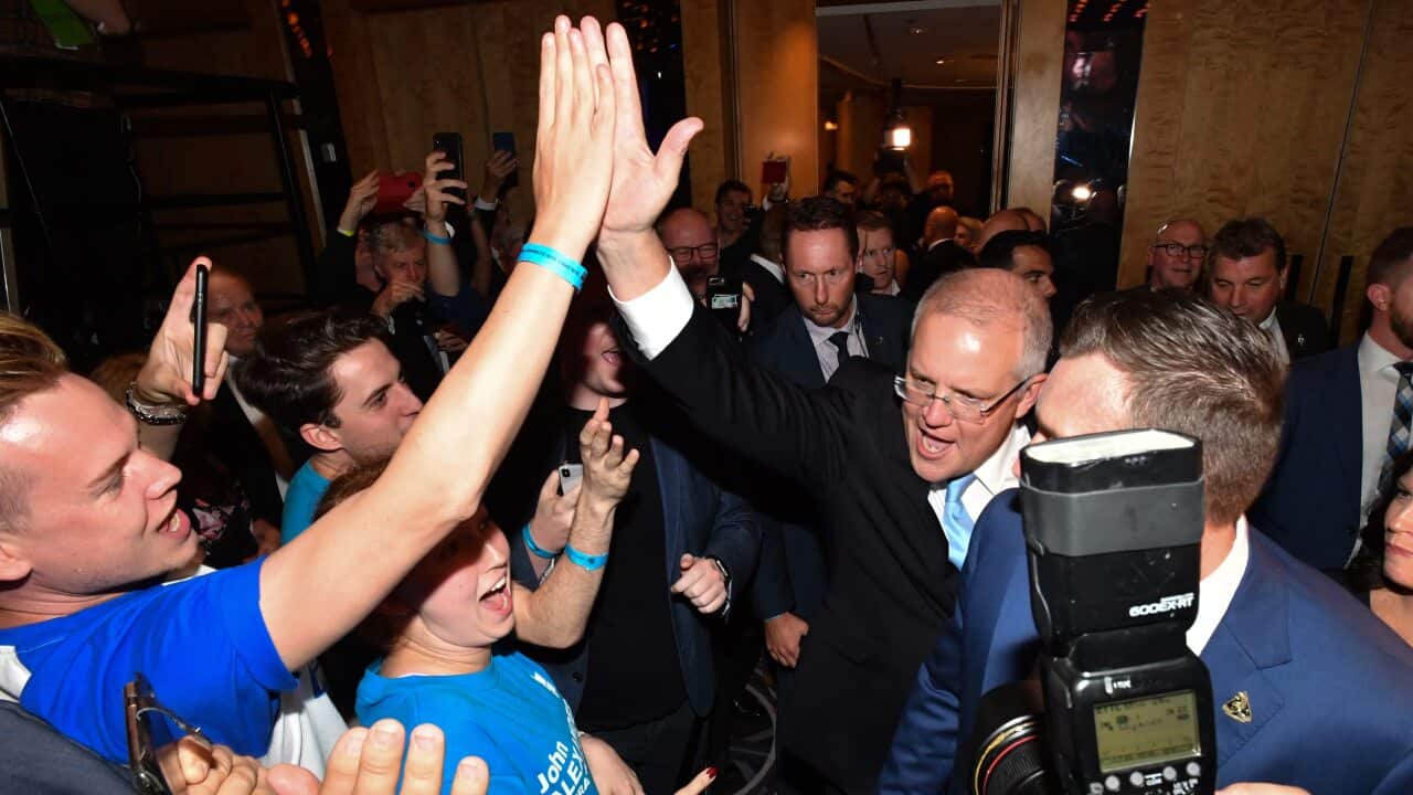 A jubilant Scott Morrison greets Liberal supporters after emerging ahead of his victory speech.