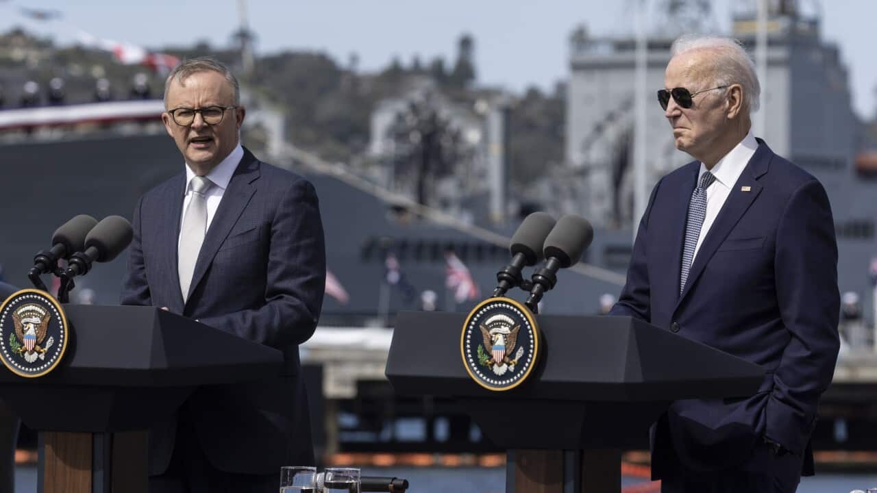 Australia's leader Anthony Albanese and US President Joe Biden stand at podiums