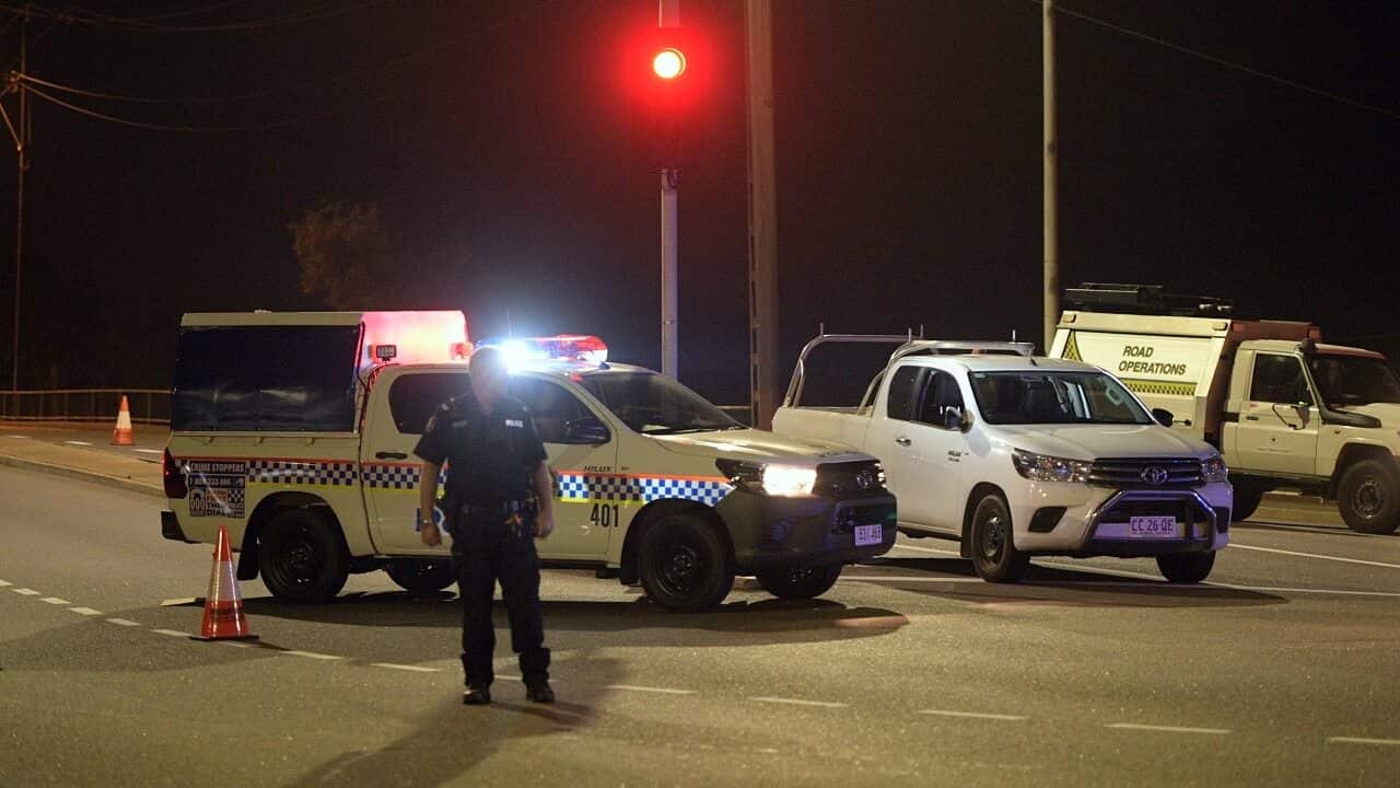 Police at a crime scene on the intersection of McMinn Street and Stuart Highway in Darwin.