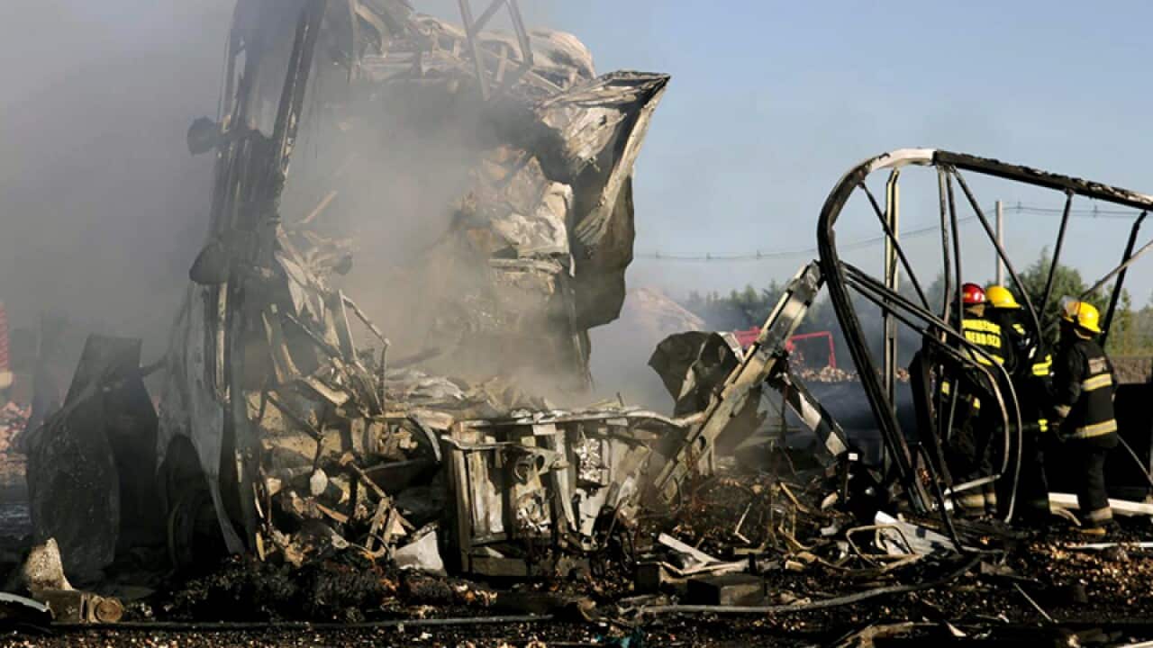 The wreckage of a bus and a truck that collided in San Martin
