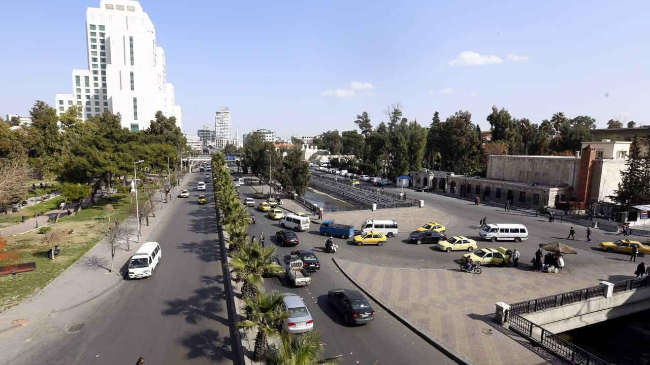 Vehicles drive at a street after a ceasefire that went into effect in the capital Damascus