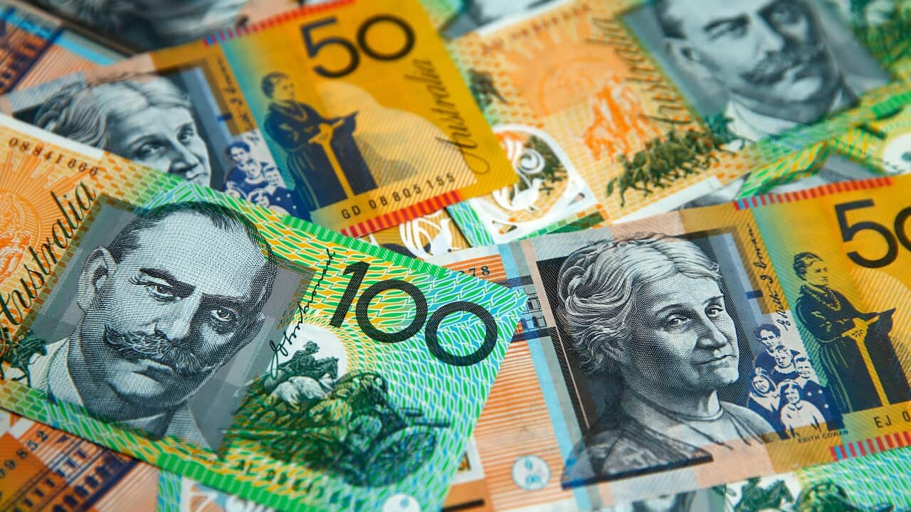 $50 and $100 Australian banknotes are arranged for a photograph.