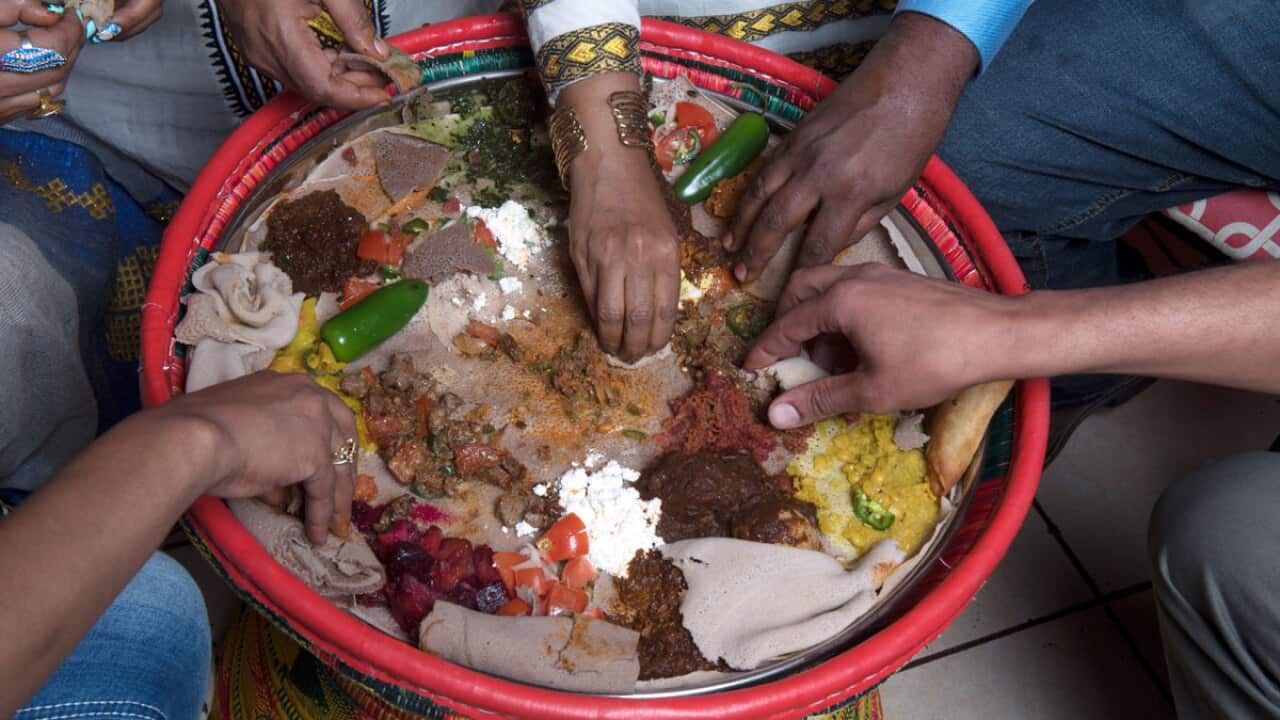 Eating Ethiopian food 