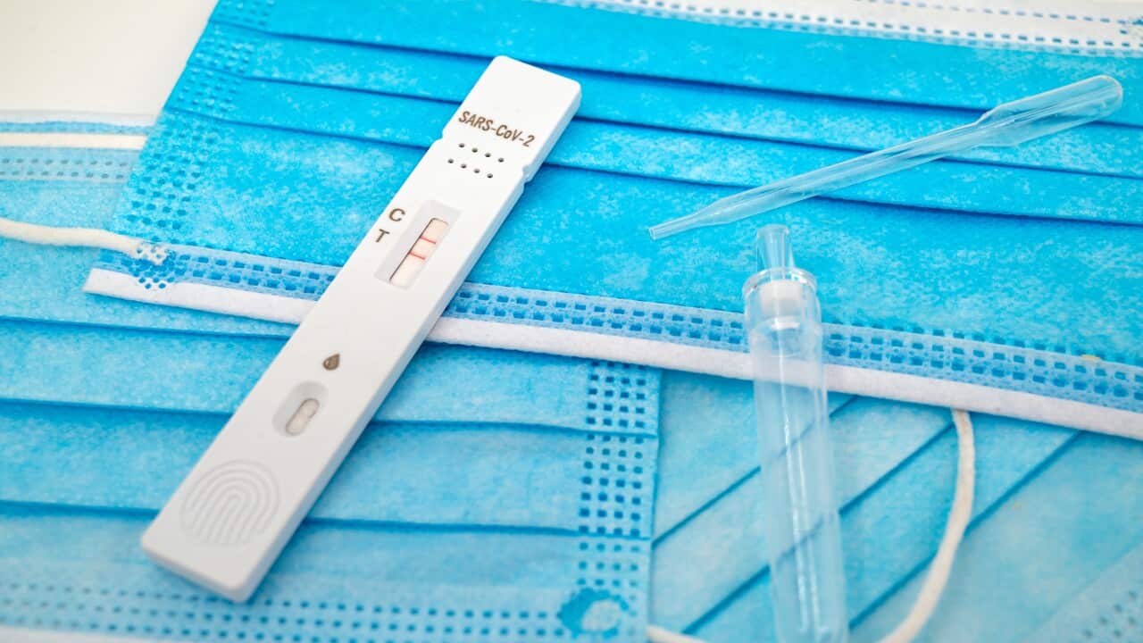 A positive COVID-19 test on top of protective face masks.